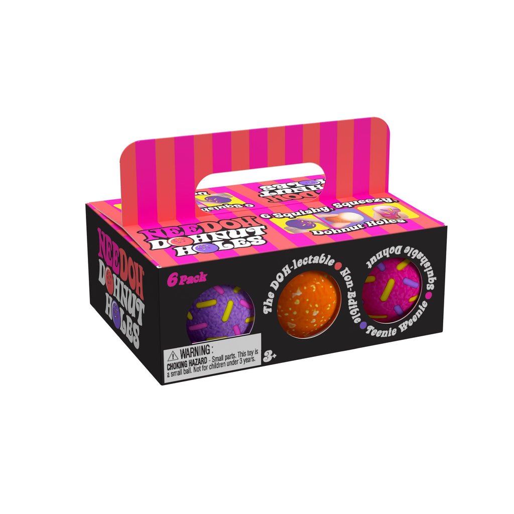 A box of 'NeeDoh Dohnut Holes Y2' sensory balls, designed to look like a 6-pack of donut holes. The packaging is black with pink and orange stripes on the handle and top. The front of the box features images of two sensory balls: one purple with pink and yellow sprinkles, and one orange with white sprinkles. The text on the box includes phrases like 'The DOH-lectable', 'Squishable', 'Non-Edible', and 'Teenie Weenie'. There is a warning label indicating the toy is for ages 3 and up due to small parts.