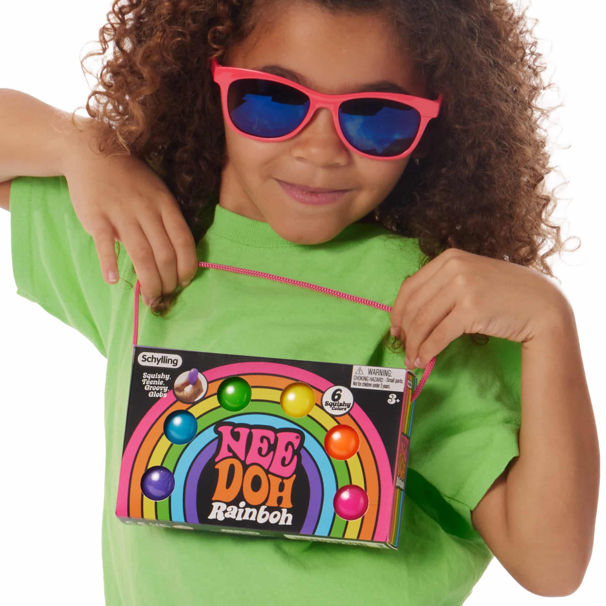 Girl holding the NeeDoh Rainboh Q3 packaging